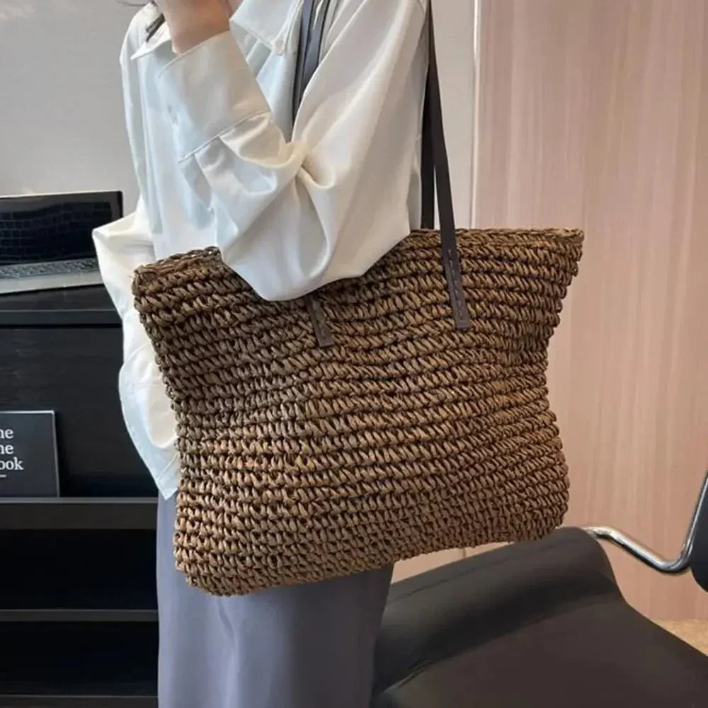 Woven straw tote bag front view with round top handles