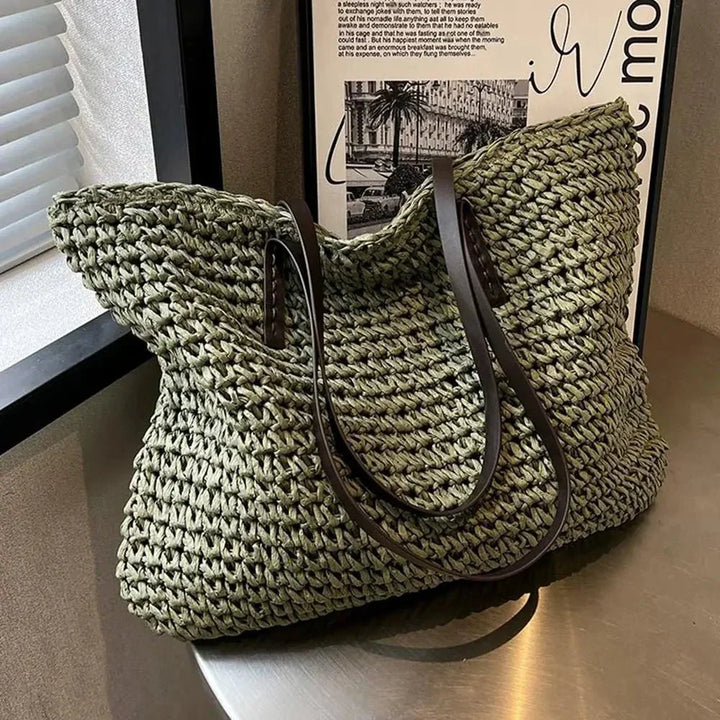Straw shoulder tote bag carried over the arm
