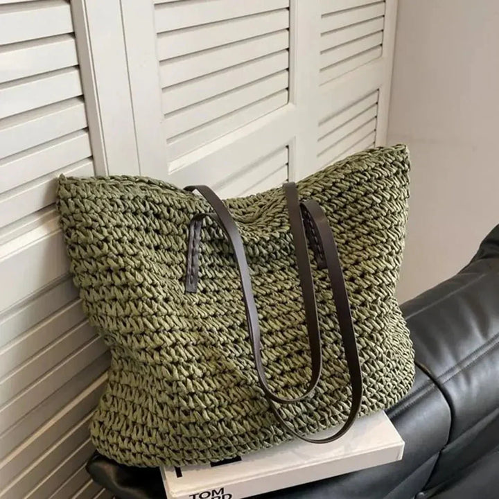 Side view of rectangular woven straw tote bag